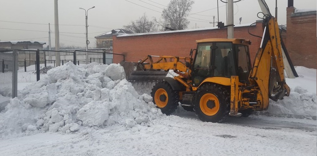 Экскаватор погрузчик для уборки снега и погрузки в самосвалы для вывоза в Каспийском